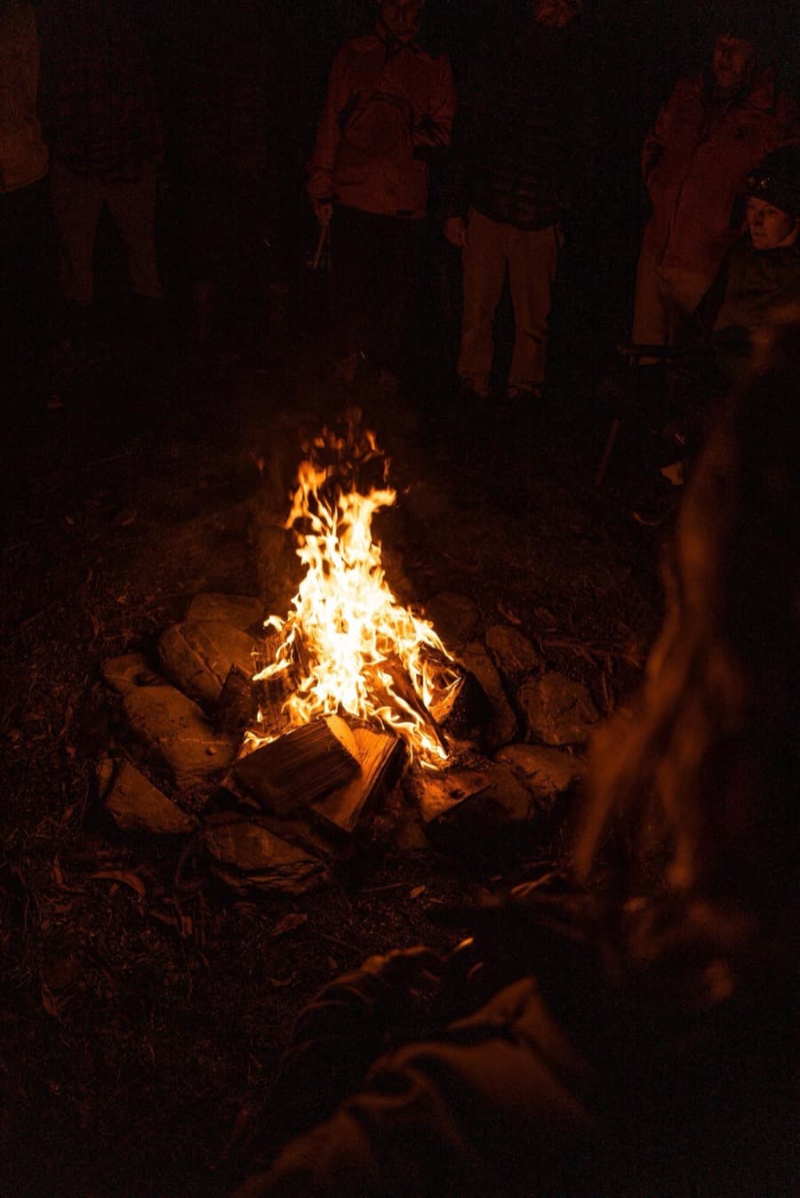 Men gathered around a fire at night